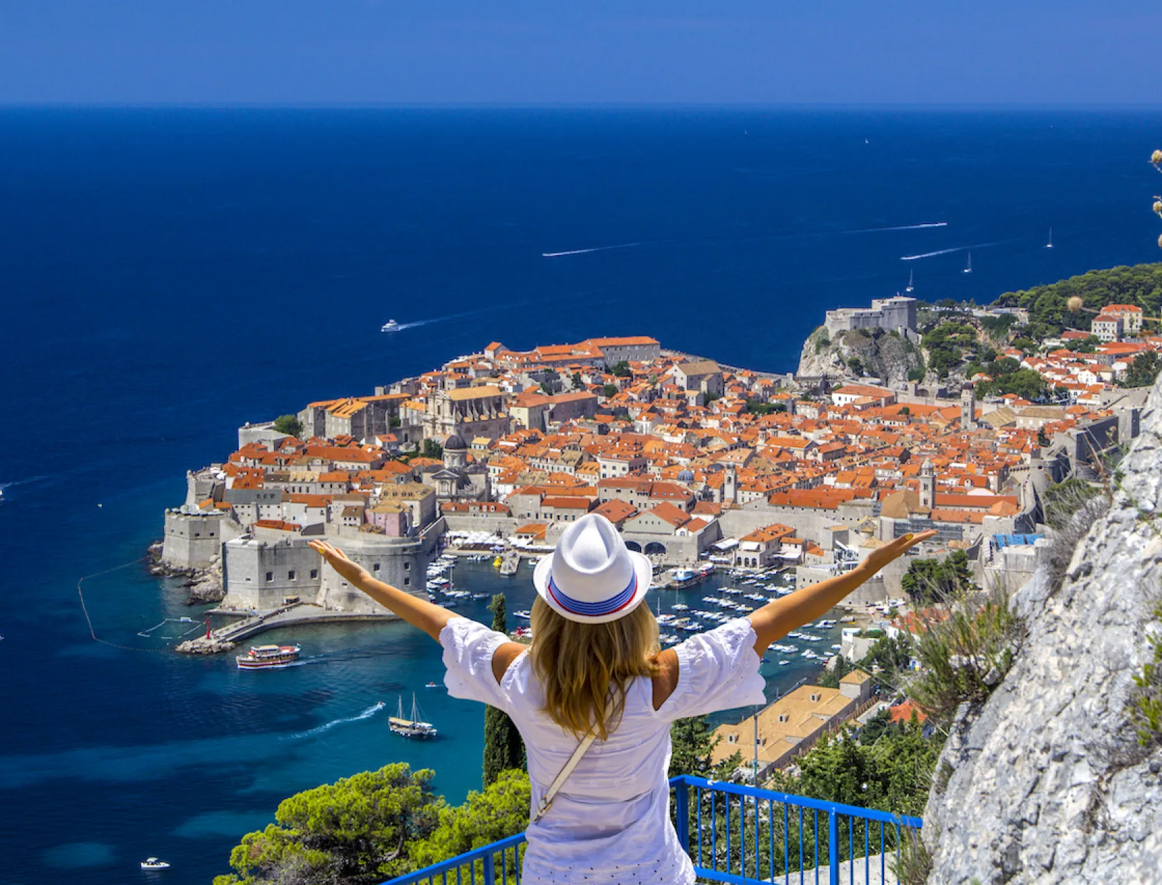 Happy-Girl-Enjoys-View-Of-Old city of Dubrovnik