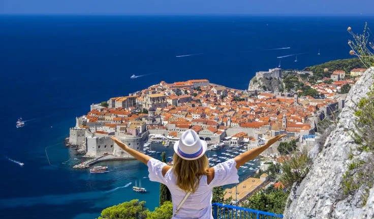 Happy-Girl-Enjoys-View-Of-Old city of Dubrovnik