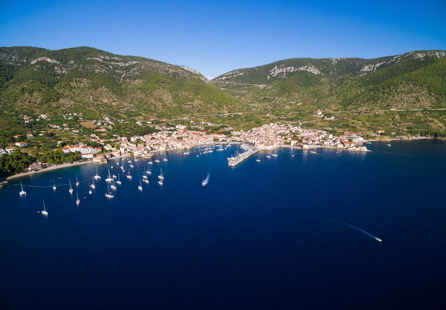 Komiza town and boats docked in marina on Vis Island