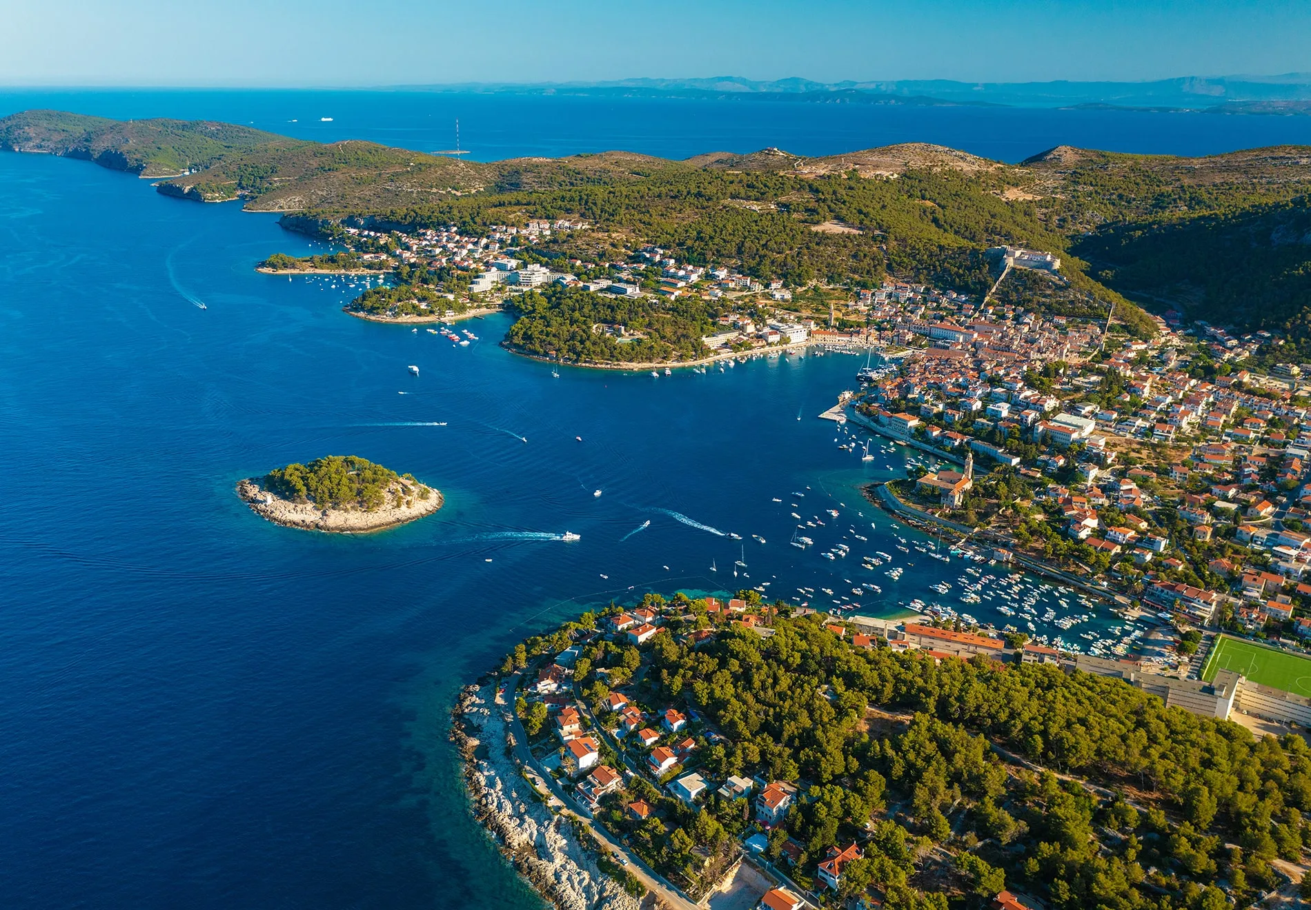 Cruise along the picturesque Adriatic coast, stopping at charming islands like Hvar and Brač