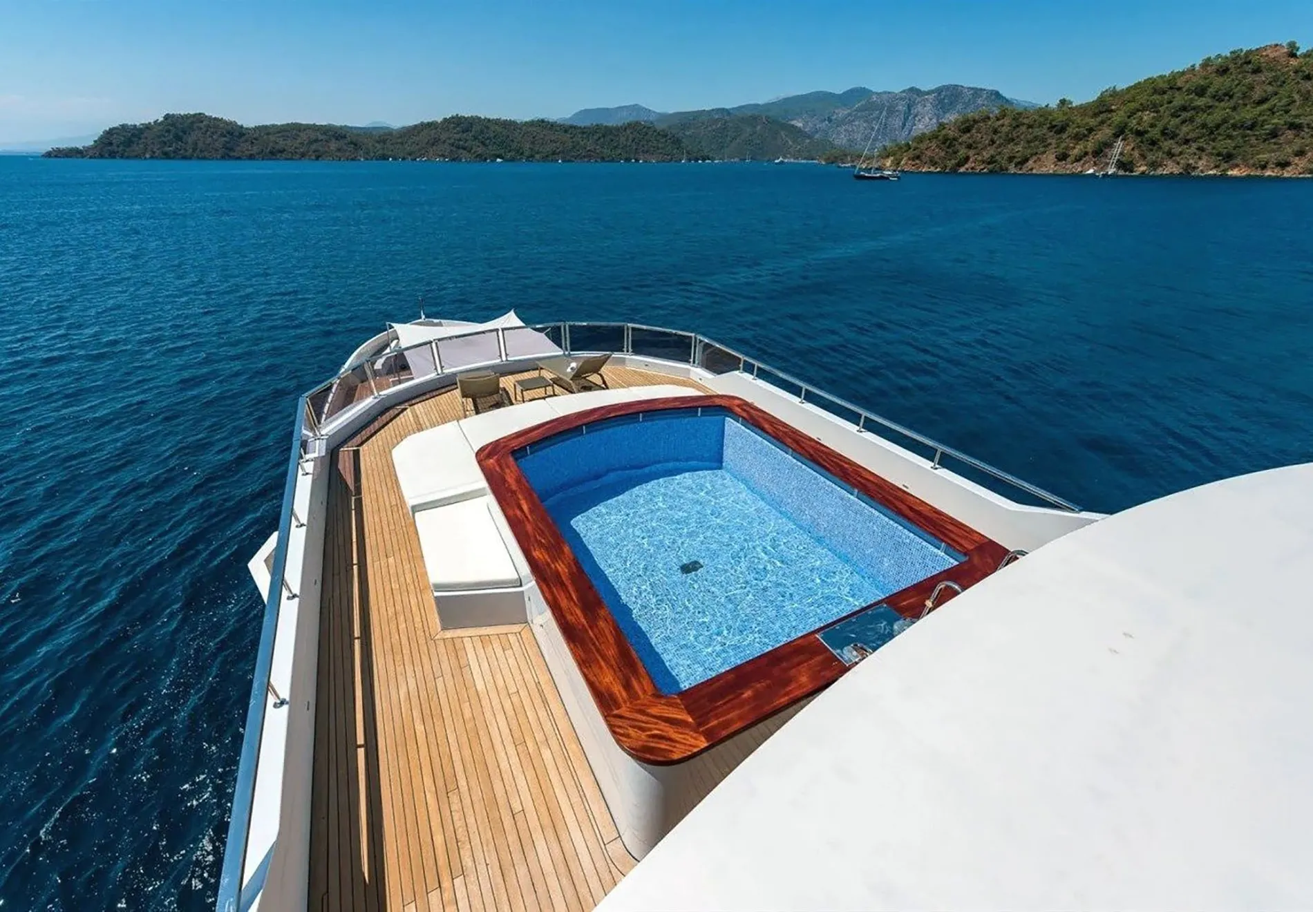 Guests can unwind in sumptuous living areas or cool off in the onboard pool. The yacht also features a beach club for seamless indoor-o