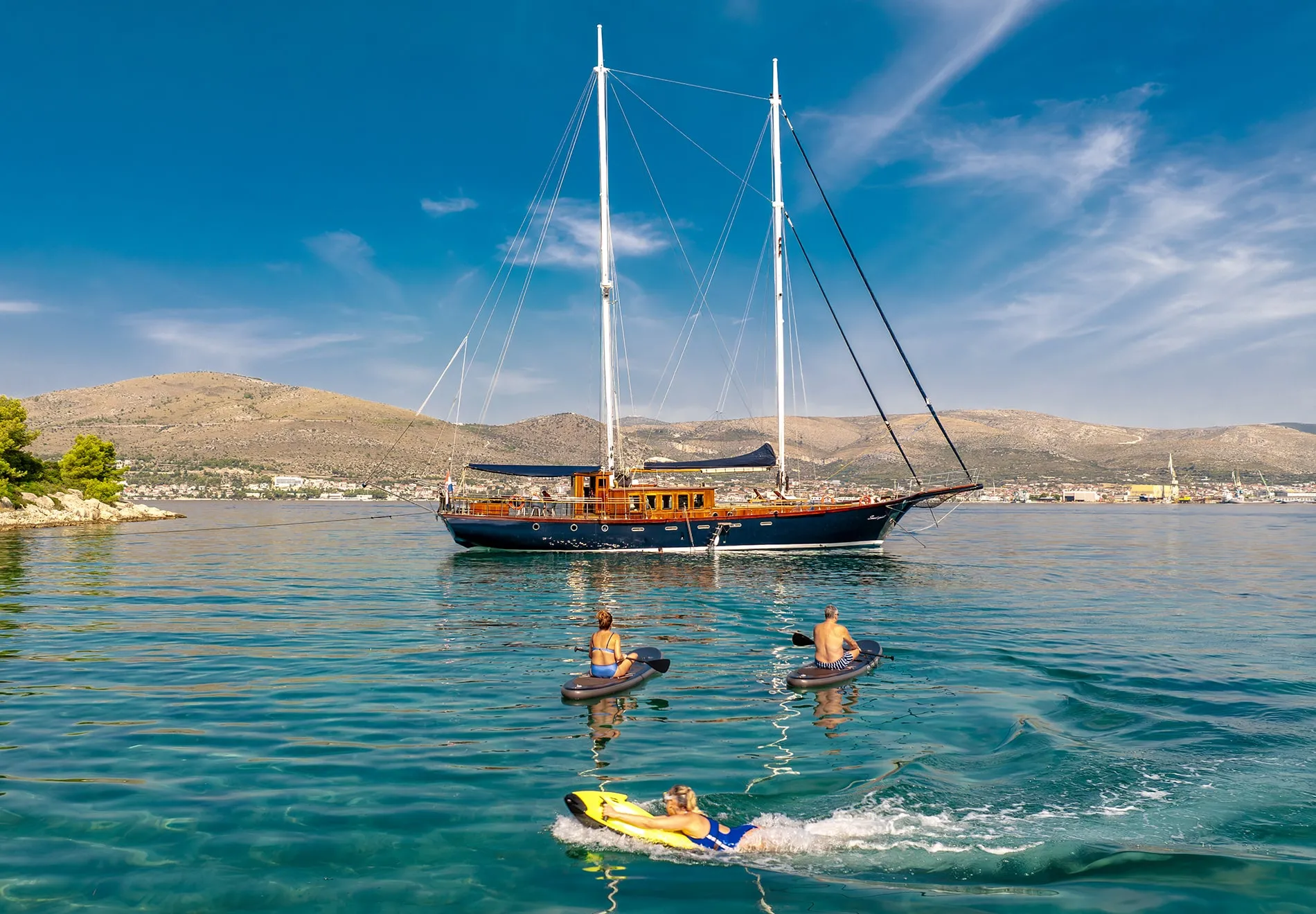 Onboard, a wealth of water toys awaits a jet ski, sea scooters, waterskis, tube rides, paddleboards, and canoes, alongside snorkeling gear and