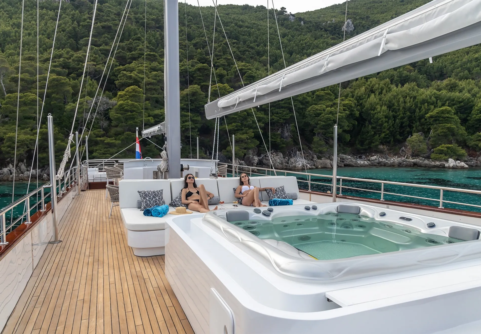 Step into the charming outdoor areas with a dining area, jacuzzi on the flybridge, and additional seating for evening gatherings, ideal for enjoying t