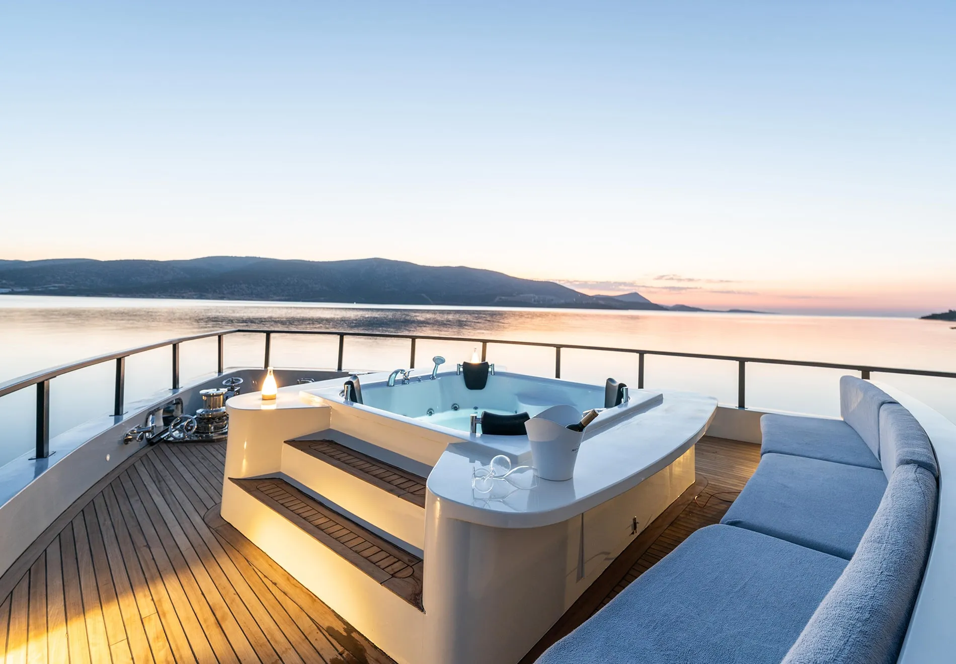 The yacht shines in outdoor living, featuring a spacious deck with a jacuzzi, ideal for enjoying scenic views and cocktails