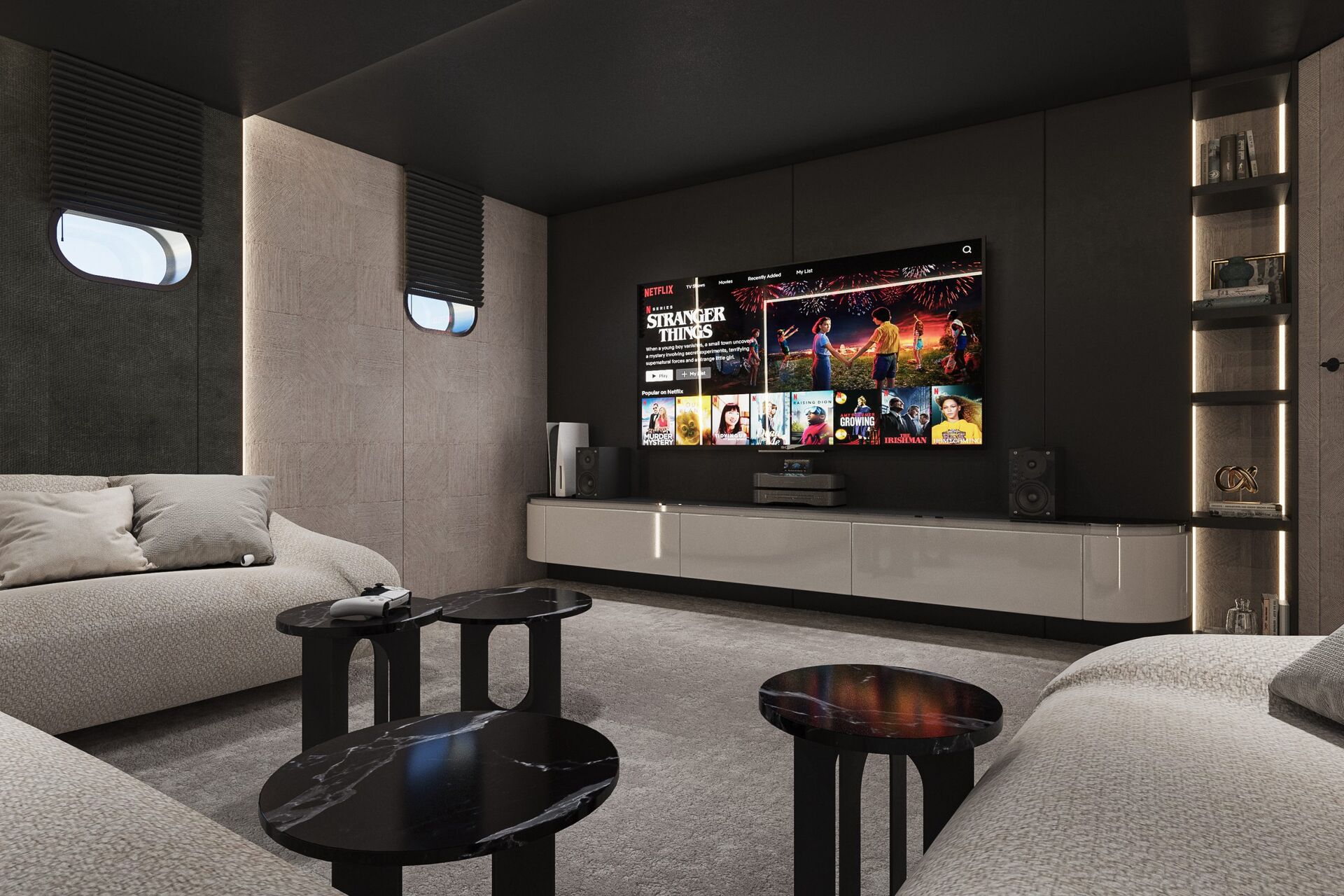A modern home theater room with two beige sofas, black marble coffee tables, and a large wall-mounted TV displaying Netflix and the show Stranger Things, surrounded by dark walls and soft lighting.