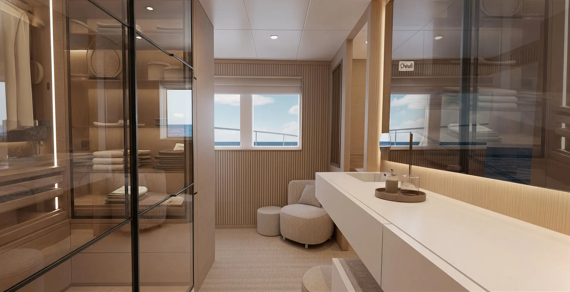 Modern, luxurious bathroom with large mirrors, a sleek white vanity, neatly folded towels on glass shelves, a round ottoman, and two windows showing a view of the ocean and sky.