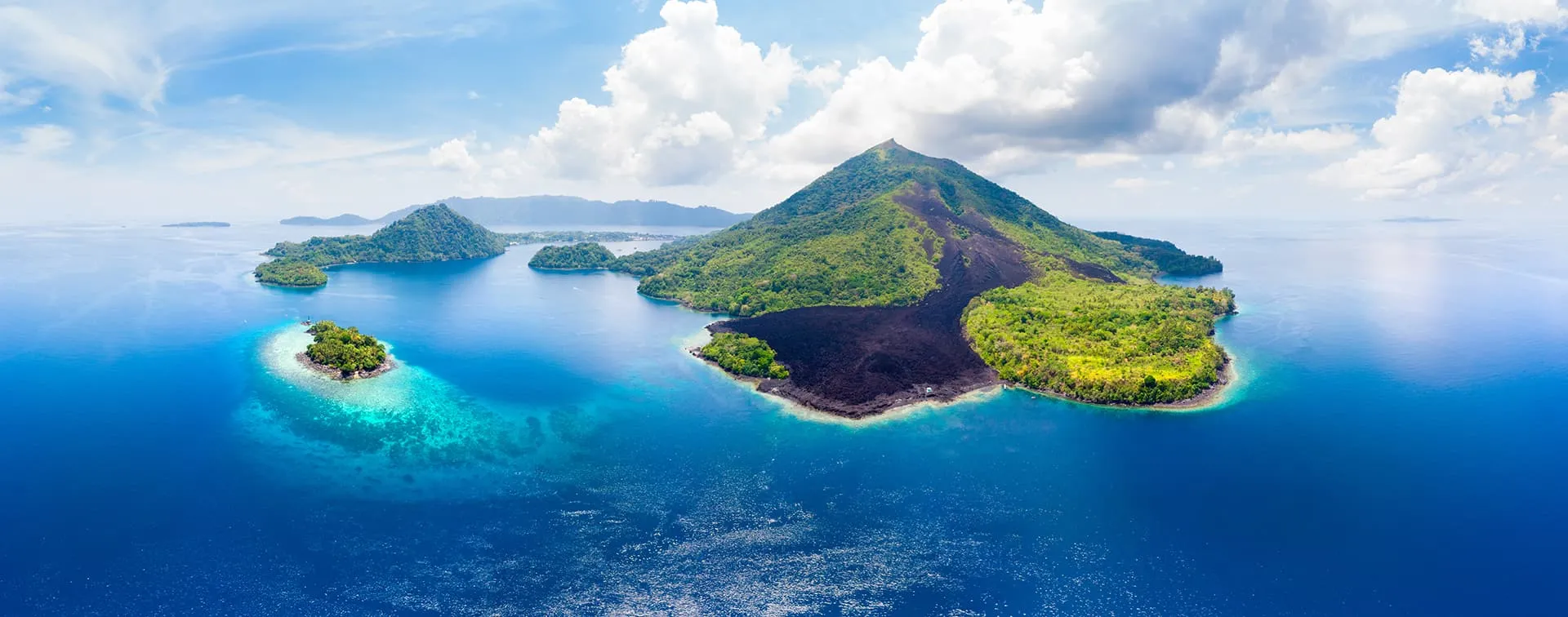 Aerial-view-Banda-Islands-Moluccas-archipelago-Indonesia-Pulau-Gunung-Api-lava-flows-coral-reef-white-sand-beach.-Top-travel-tourist-destination-best-diving-snorkeling