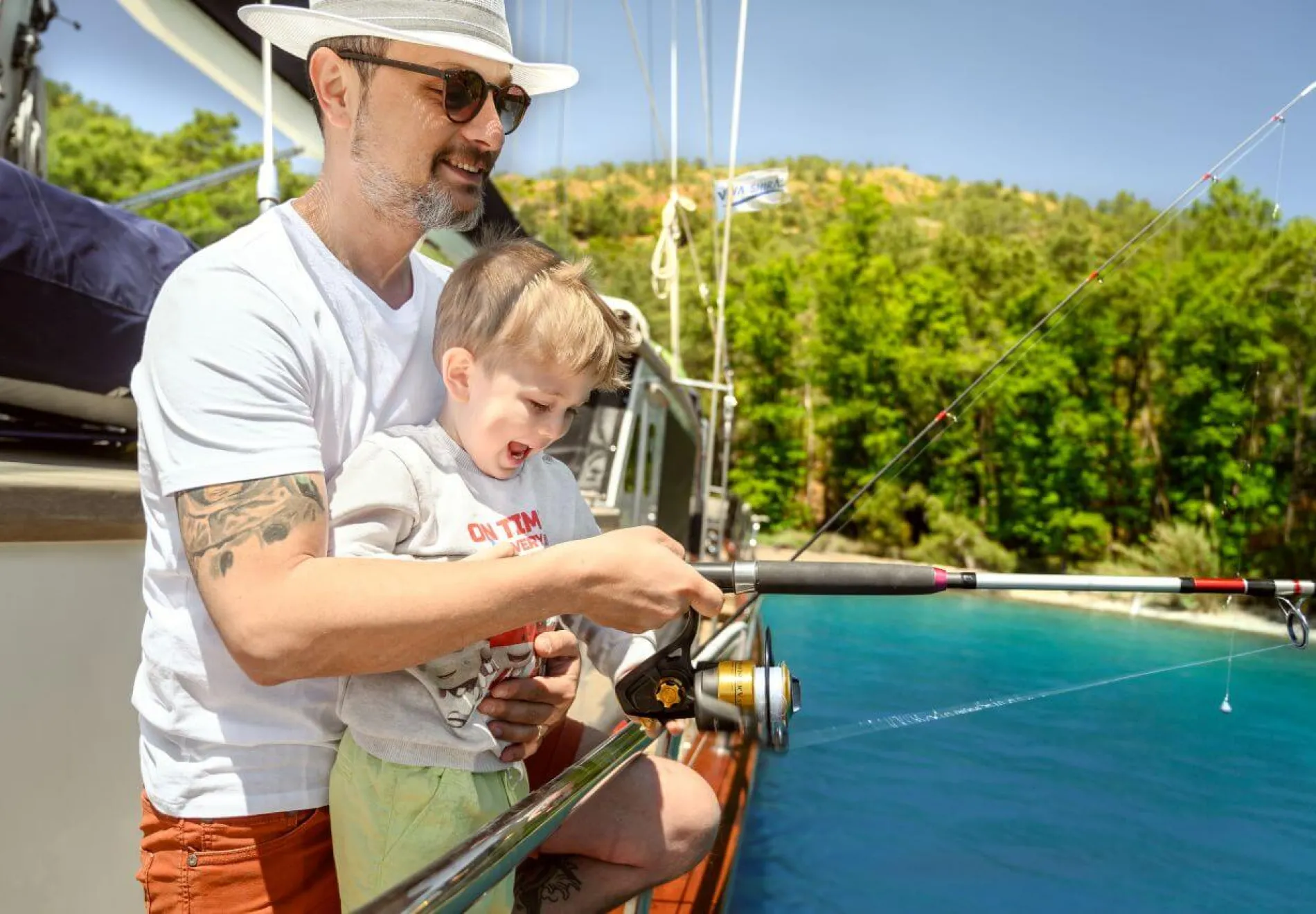 Family gulet cruise Turkey - Dad and son fishing from a gulet in Turkey