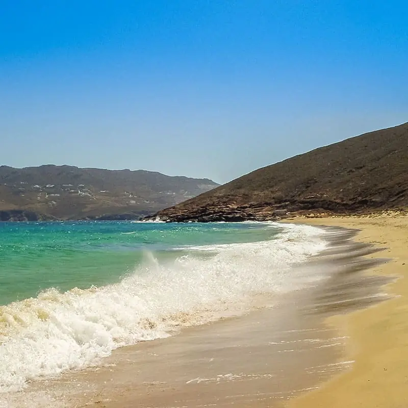 The sandy Ftelia beach with blue sky and turquoise sea in the aegean sea in Mykonos Greece